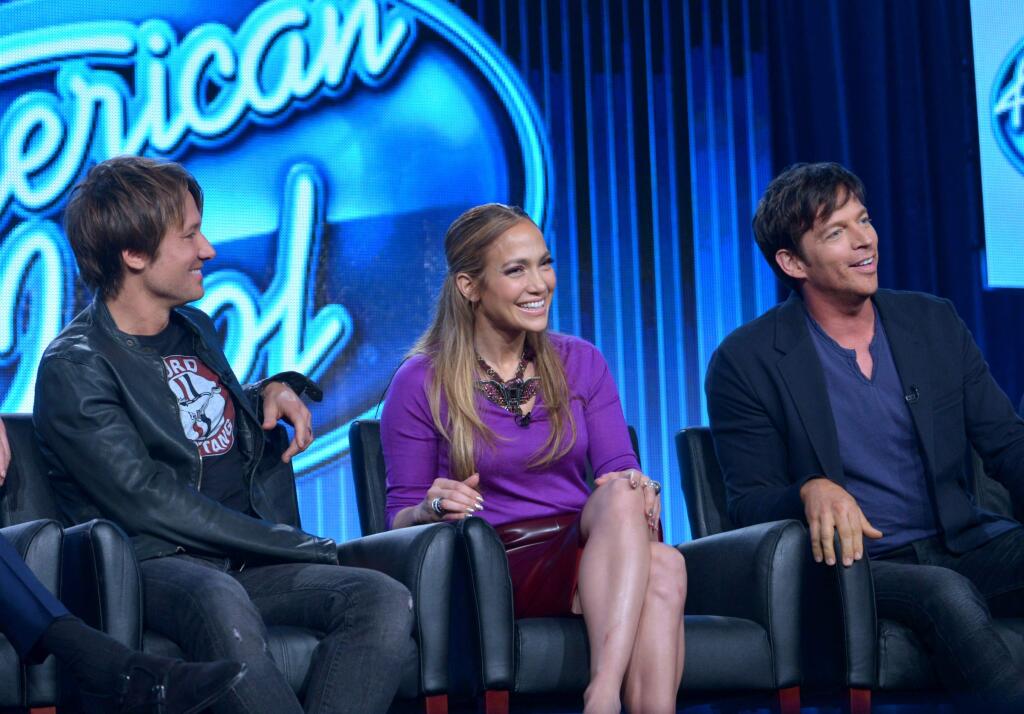 FILE - In this Jan. 13, 2014 file photo, judges, from left, Keith Urban, Jennifer Lopez, and Harry Connick Jr. are seen during the panel of 'American Idol' at the FOX Winter 2014 TCA, at the Langham Hotel in Pasadena, Calif. (Photo by Richard Shotwell/Invision/AP, file)