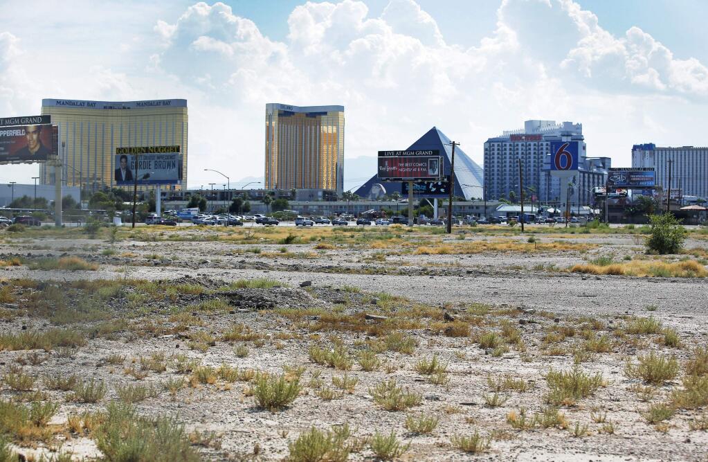 FILE - In this July 1, 2016, file photo, a vacant lot that is the site of a proposed football stadium sits near McCarran International Airport in Las Vegas. NFL owners approved the Oakland Raiders' move to Las Vegas on Monday morning, March 27, 2017, at the league meetings. (AP Photo/John Locher, File)