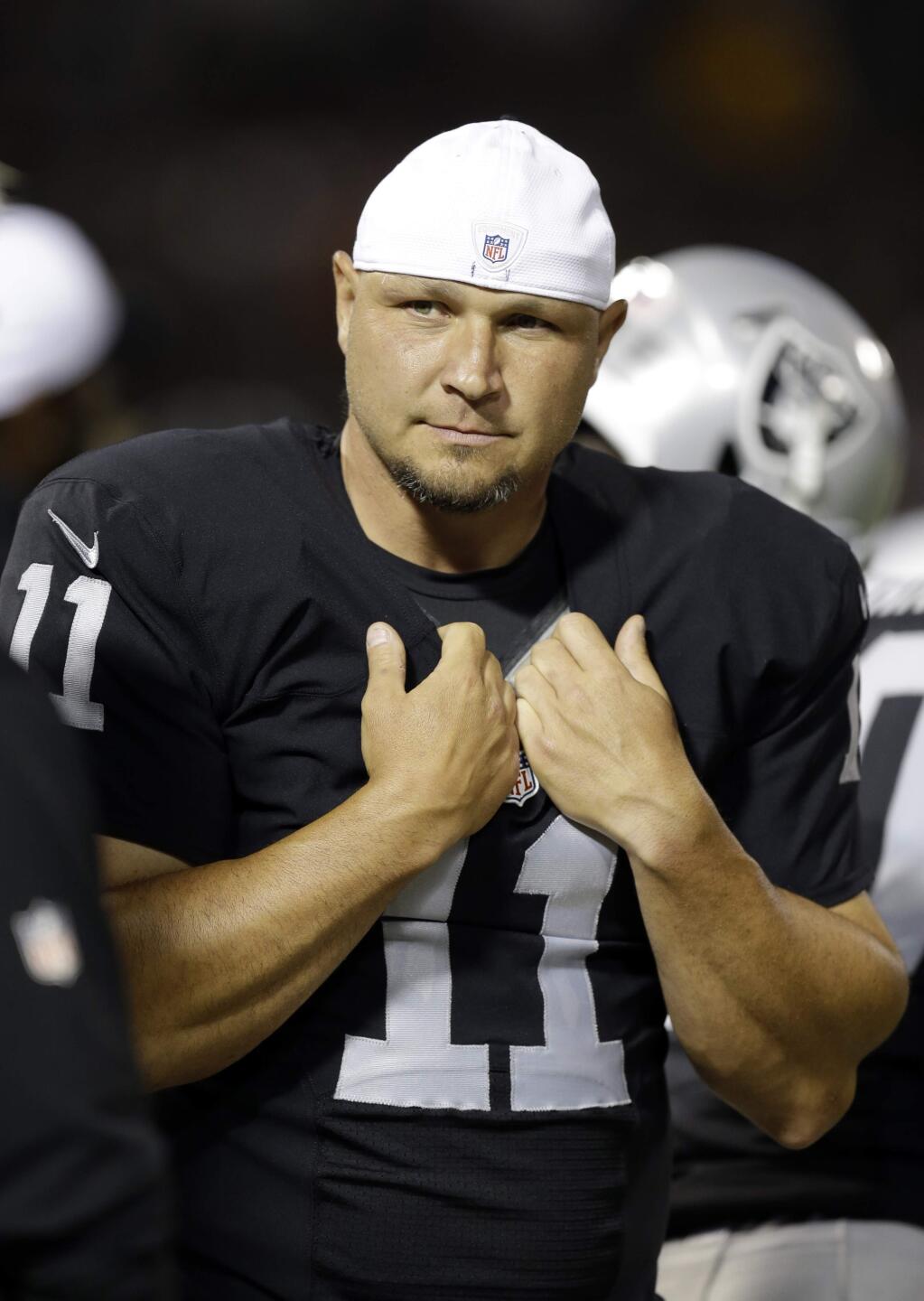 FILE - In this Aug. 14, 2015, file photo, Oakland Raiders place kicker Sebastian Janikowski (11) watches from the sidelines during an NFL preseason football game against the St. Louis Rams in Oakland, Calif. Janikowski is about to set the franchise record for games played with No. 241 Sunday, Oct. 11, 2015, against Denver. (AP Photo/Ben Margot, File)