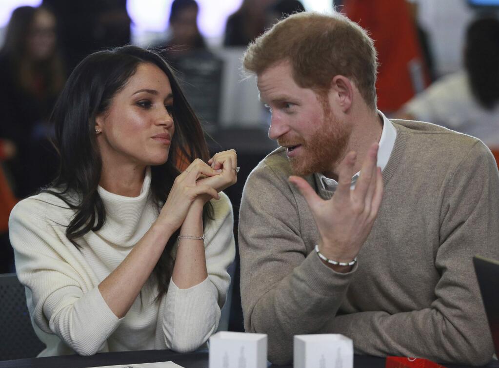 Britain's Prince Harry and Meghan Markle take part in an event as part of International Women's Day in Birmingham, central England, Thursday, March 8, 2018. (Ian Vogler/Pool via AP)
