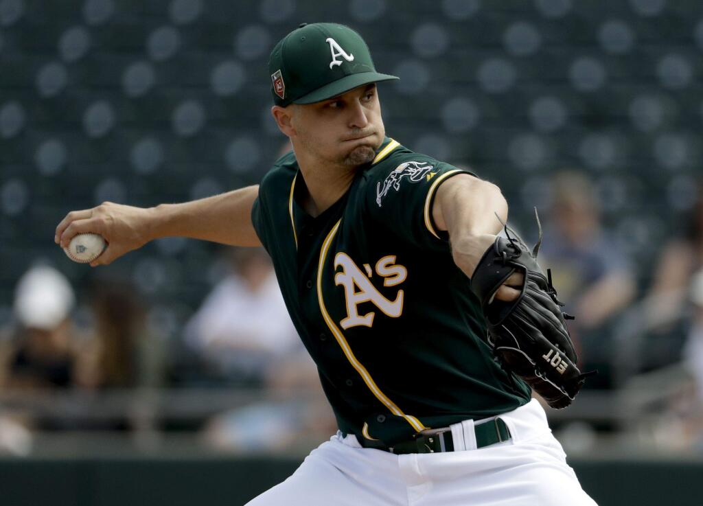 In this March 8, 2018, file photo, Oakland Athletics starting pitcher Kendall Graveman throws against the Los Angeles Angels during the first inning in Mesa, Ariz. Graveman will take the ball on opening day for Oakland in a second consecutive season, eager to be the leader of a young rotation at age 27. (AP Photo/Chris Carlson, File)