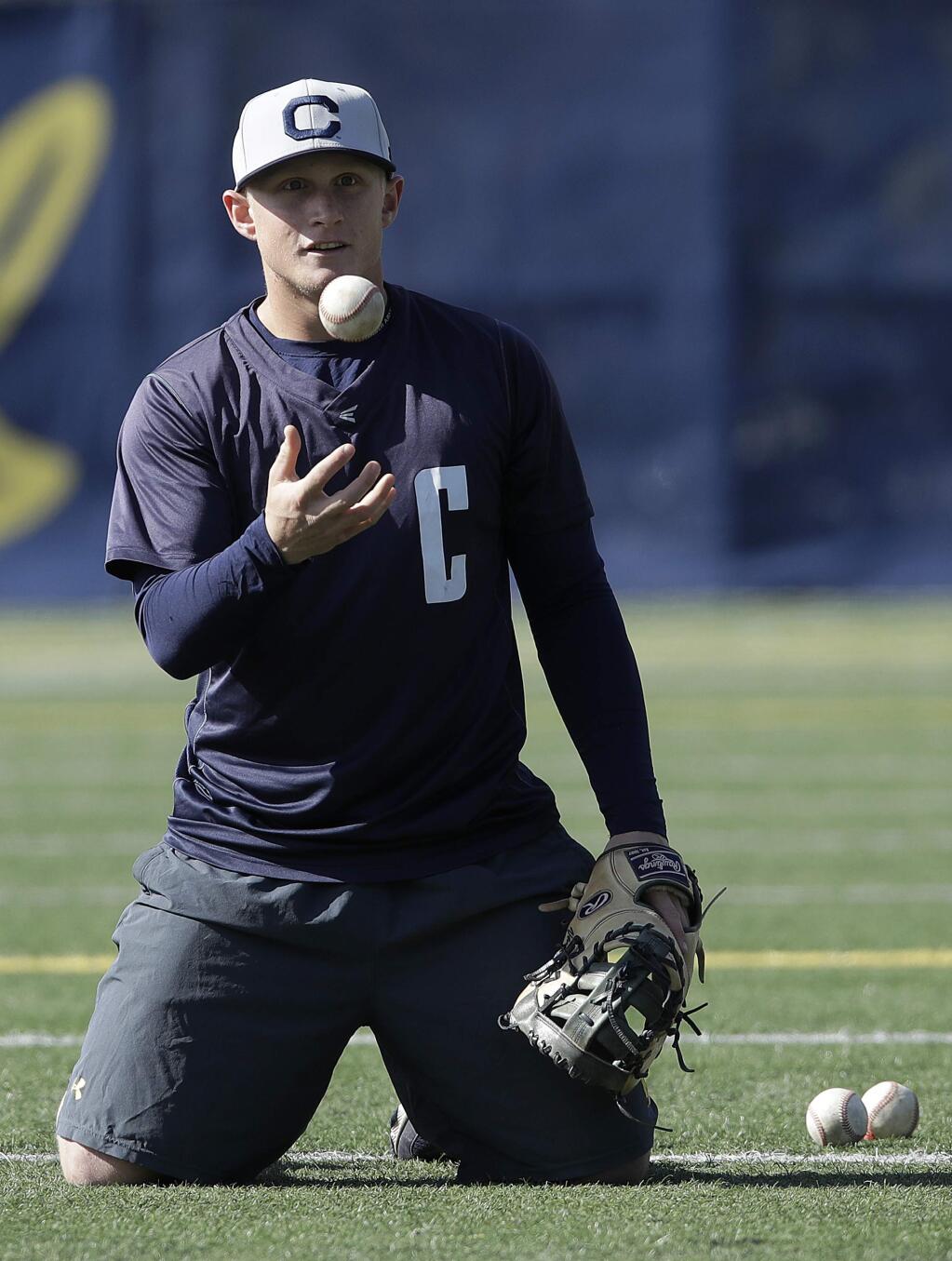 In this photo taken March 6, 2019, Cal's Andrew Vaughn flips a ball during baseball practice in Berkeley. (AP Photo/Jeff Chiu)