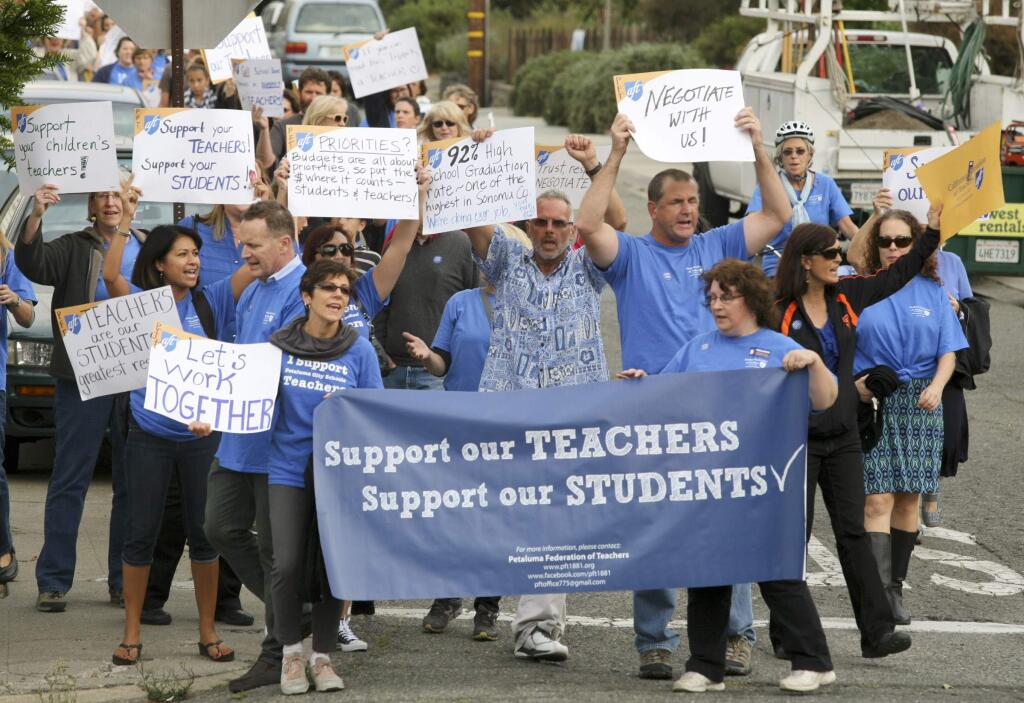 Petaluma teachers march through the streets of Petaluma in route to a press conference in front of the Petaluma City School's District office before the school board meeting on Tuesday, October 14, 2014. (SCOTT MANCHESTER/ARGUS-COURIER STAFF)