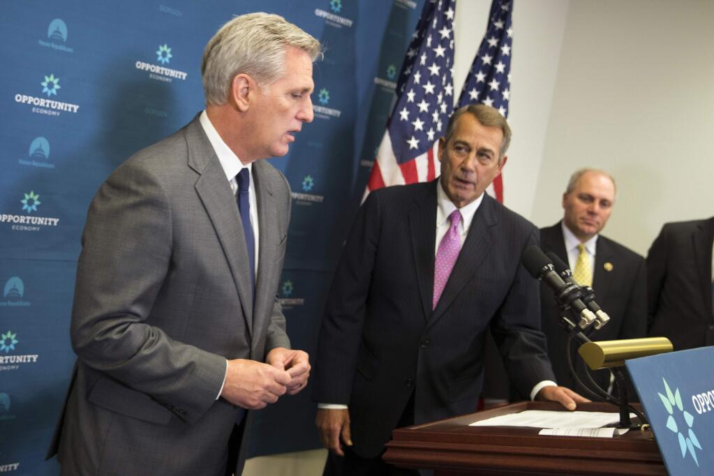 House Majority Leader Kevin McCarthy, accompanied by outgoing House Speaker John Boehner and House Majority Whip Steve Scalise, speaks during a news conference Wednesday following the weekly House Republican Conference meeting. (EVAN VUCCI / Associated Press)