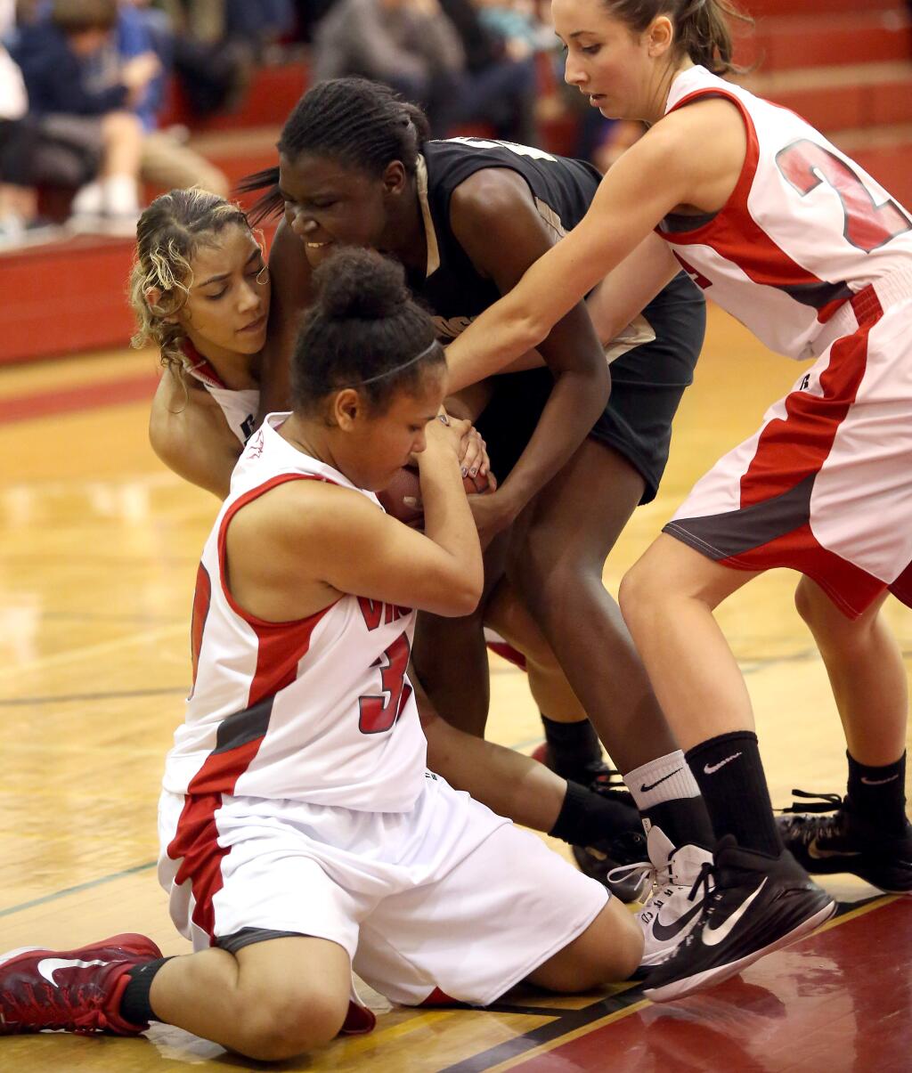 Windsor's Jessica Barbosa, center top, fights for the ball against Montgomery's LaDonna Saint Louis, left, Jazmin Basmajian, center bottom and Paige Raven, right, during the game held at Montgomery High School, Friday, February 6, 2015. (Crista Jeremiason / The Press Democrat)