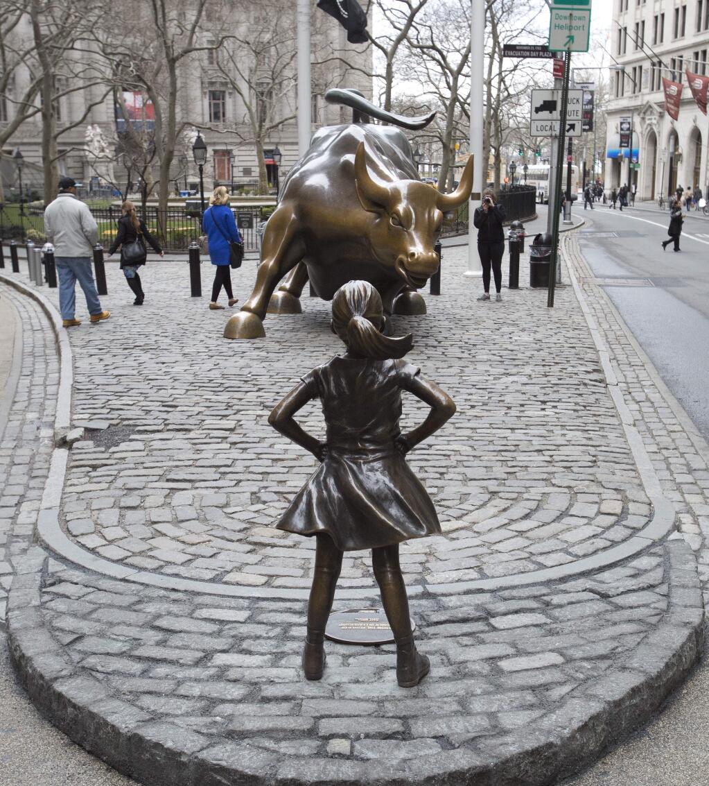 The 'Fearless Girl' statue faces Wall Street's charging bull statue. (MARK LENNIHAN / Associated Press)
