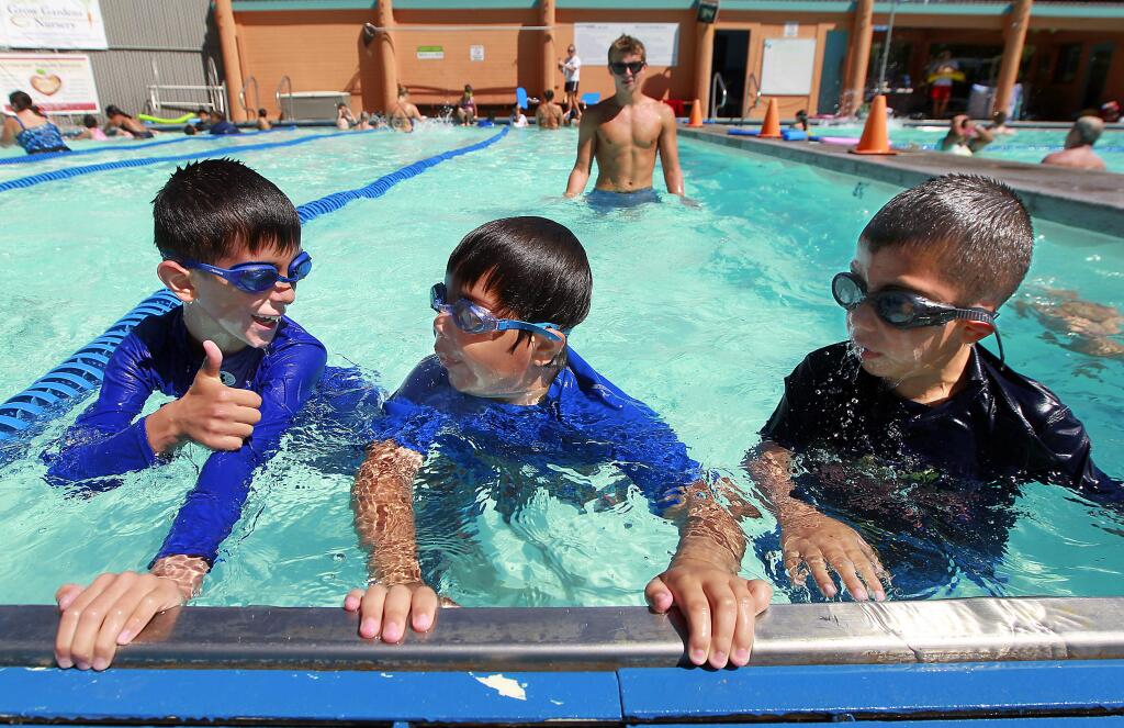 6/29/2014:B7: Diego Padilla, left, Antonio Lozoida and Angel Machuca practice kicks Saturday during their Vamos a Nadar class. PC: (l to r) Diego Padilla, Antonio Lozoida and Angel Machuca practice their kicking at Ives Pool in Sebastopol. The Vamos a Nadar program sponsored by the American Red Cross offered spanish speaking swimming lessons.