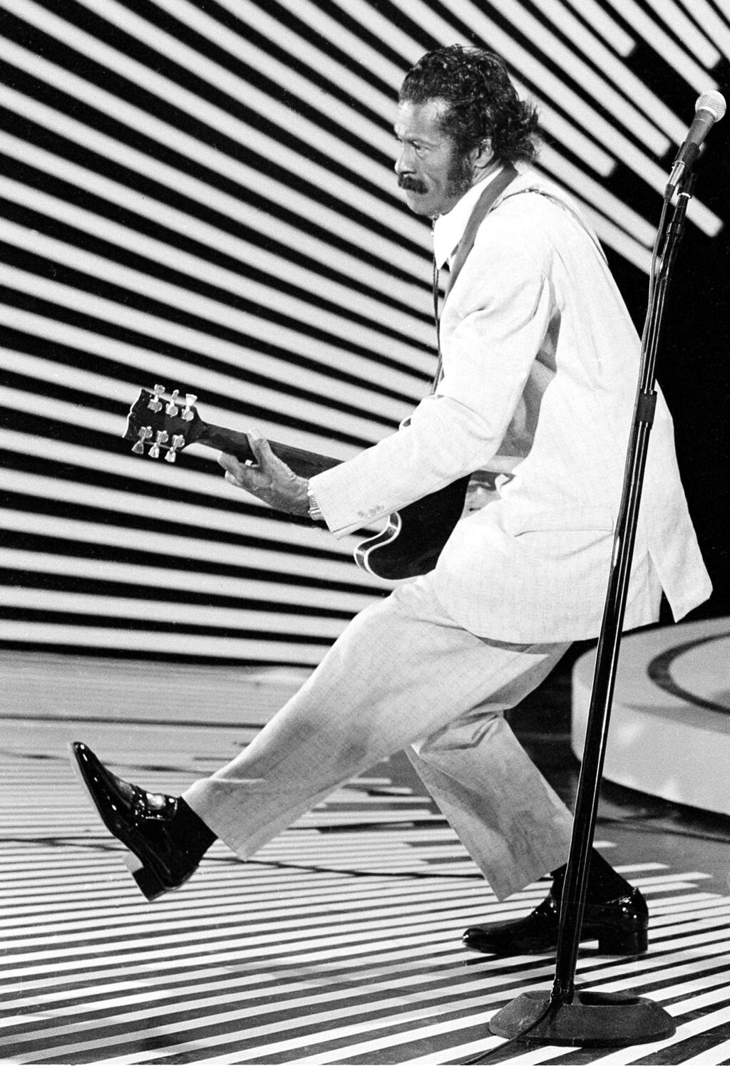 FILE - In this April 4, 1980 file photo, guitarist and singer Chuck Berry performs his 'duck walk' as he plays his guitar on stage. On Saturday, March 18, 2017, police in Missouri said Berry has died at the age of 90. (AP Photo)