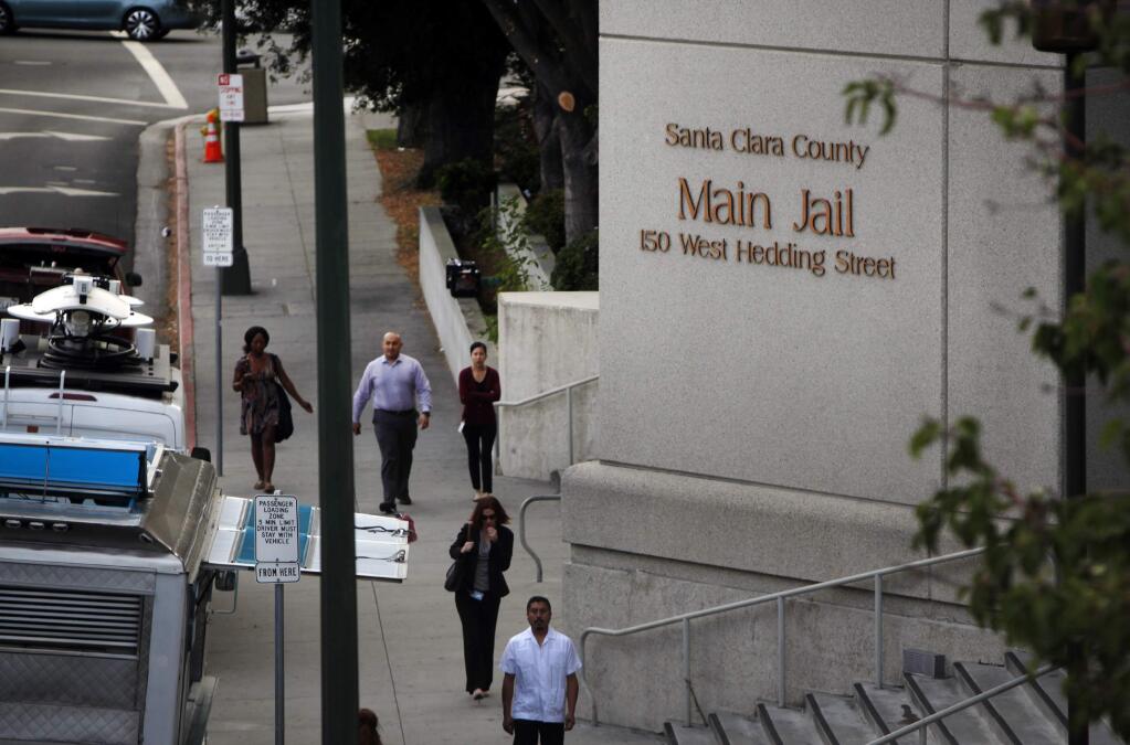 In this photo taken, Wednesday Sept. 2, 2015, pedestrians walk past the Santa Clara County Jail in San Jose, Calif. Three California correctional deputies have been arrested on suspicion of murder in the death of an inmate at a county jail, Santa Clara County Sheriff's spokesman Sgt. James Jensen said Thursday, Sept. 3, 2015. Thirty-one-year-old Michael Tyree died last week at the jail after he had pleaded no contest to petty theft, The San Jose Mercury News reported. (Karl Mondon(/San Jose Mercury News via AP) MAGS OUT; NO SALES; MANDATORY CREDIT