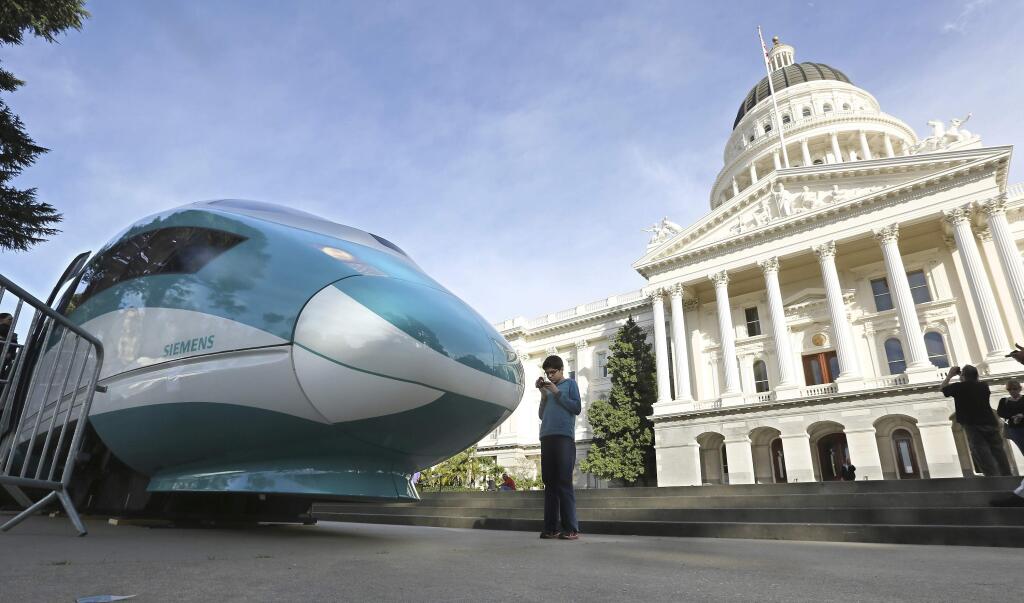 FILE - In this Feb. 26, 2015, file photo, a full-scale mock-up of a high-speed train is displayed at the Capitol in Sacramento, Calif. The California High-Speed Rail Authority will release its latest business plan for the bullet train, which has been beset by delays and cost increases, Friday March 9, 2018. (AP Photo/Rich Pedroncelli, file)