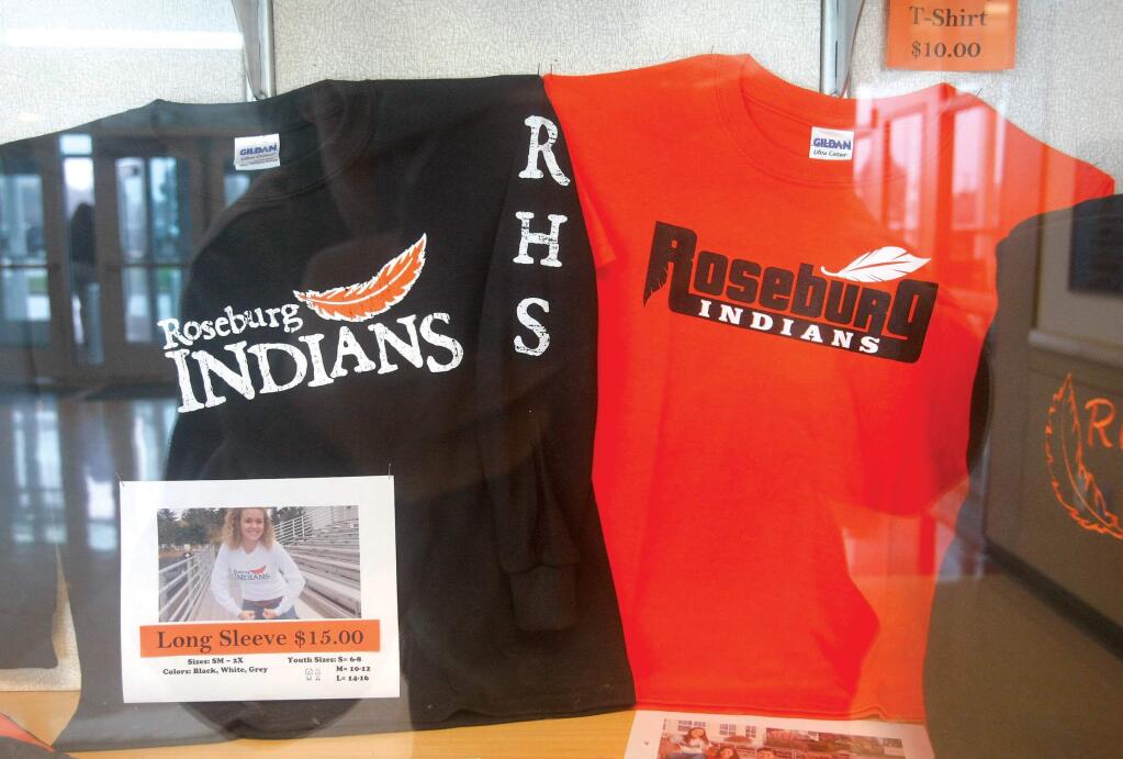 This undated file photo shows shirts with the Roseburg High School mascot name and logo for sale in the entry area of the school in Roseburg. Ore. Adidas, whose North American headquarter is in Portland, Ore., is offering to help high schools nationwide drop Native American mascots. (Michael Sullivan/The News-Review via AP)