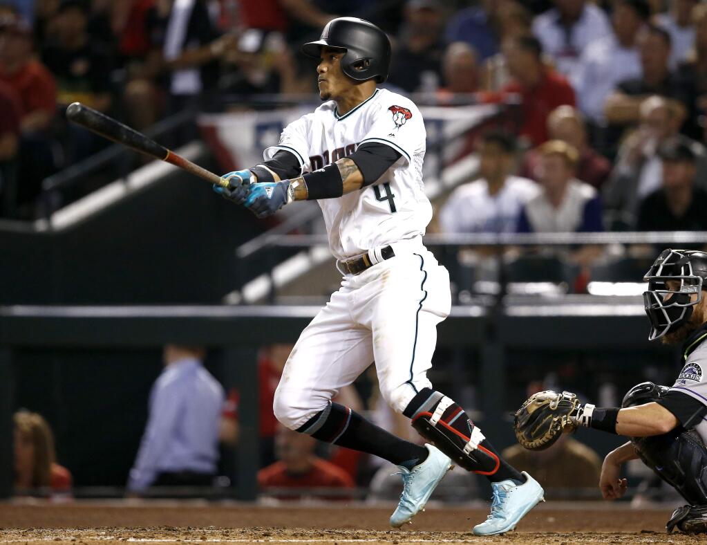 The Arizona Diamondbacks' Ketel Marte follows through on a triple against the Colorado Rockies during the fourth inning of the National League wild-card playoff game, Wednesday, Oct. 4, 2017, in Phoenix. (AP Photo/Ross D. Franklin)