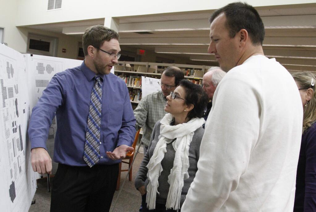 Bill Hoban/Index-Tribune 2015 file photoKevin Chapman, an architect with QKA (Quattrocchi Kwok Architects) chats with school board member Nicole Ducarroz and Tony Moll during a facility meeting in January 2015.
