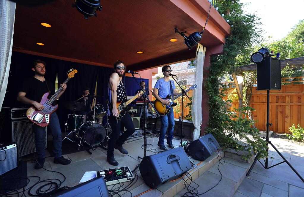 Kingsborough plays on the back porch of a house on Slater St. in Santa Rosa on Saturday night. (JOHN BURGESS / The Press Democrat)