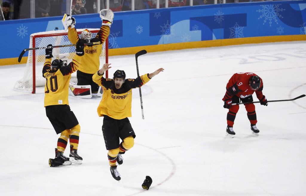 Germany players celebrate after the semifinal round of the men's hockey game against Canada at the 2018 Winter Olympics in Gangneung, South Korea, Friday, Feb. 23, 2018. Germany won 4-3. (AP Photo/Patrick Semansky)