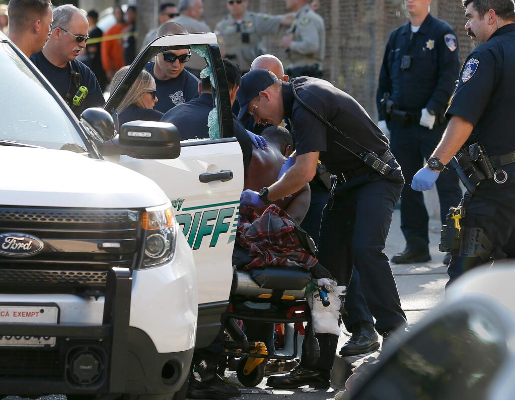 Medical personnel and law enforcement officers tend to a man on a gurney after an officer-involved shooting near the intersection of 9th and Morgan streets in Santa Rosa, California, on Thursday, Aug. 1, 2019. (ALVIN JORNADA/ PD)