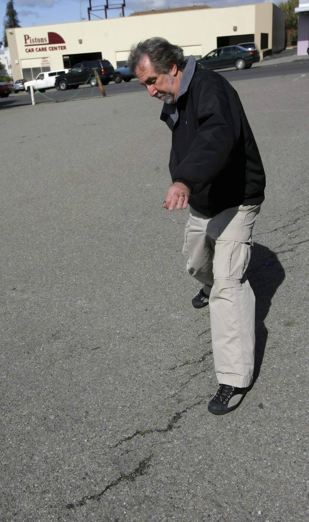 File - In this March 21, 2006, file photo, David Schwartz, geologist for the U.S. Geological Survey (USGS), walks along the Hayward Fault in a parking lot in Hayward, Calif. New research published in the journal Science Advances on Wednesday, Oct. 19, 2016, found that the Hayward Fault may be linked to another fault. (AP Photo/Jeff Chiu, File)