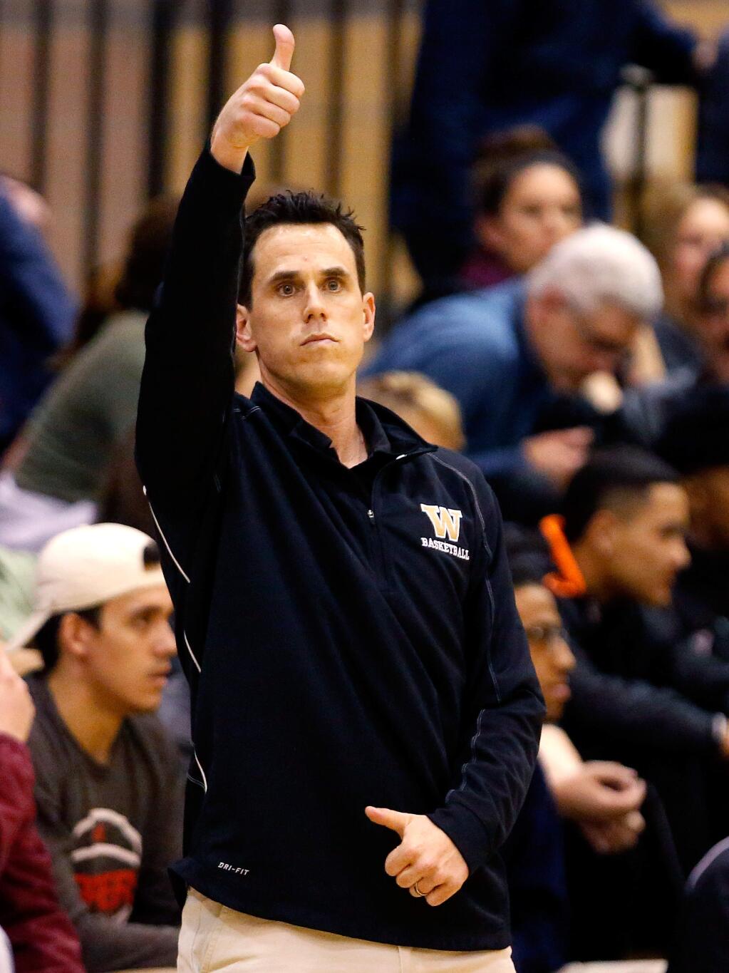 Windsor head coach Travis Taylor signals to his players during the second half of a boys varsity basketball game between Cardinal Newman and Windsor high schools in Windsor on Thursday, January 19, 2017. (Alvin Jornada / The Press Democrat)