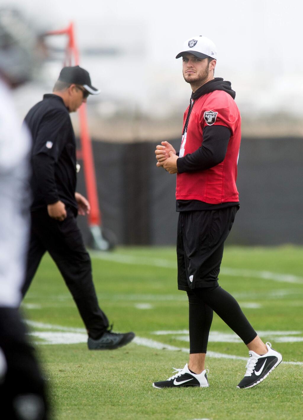 Derek Carr watches an Oakland Raiders workout on Tuesday, May 19, 2015, in Alameda, Calif. (AP Photo/Noah Berger)