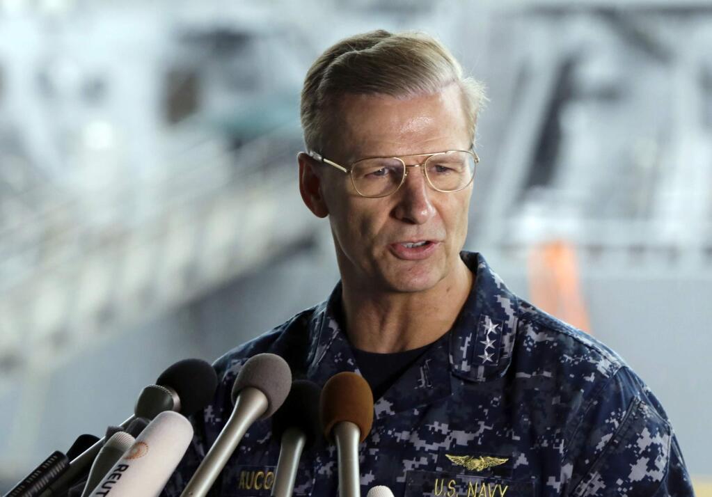 FILE - In this June 18, 2017, file photo, U.S. Navy Vice Adm. Joseph Aucoin, Commander of the U.S. 7th Fleet, speaks during a press conference, with damaged USS Fitzgerald as background at the U.S. Naval base in Yokosuka, southwest of Tokyo. U.S. officials said that Aucoin is to be relieved of duty after series of ship accidents in the Pacific. (AP Photo/Eugene Hoshiko, File)