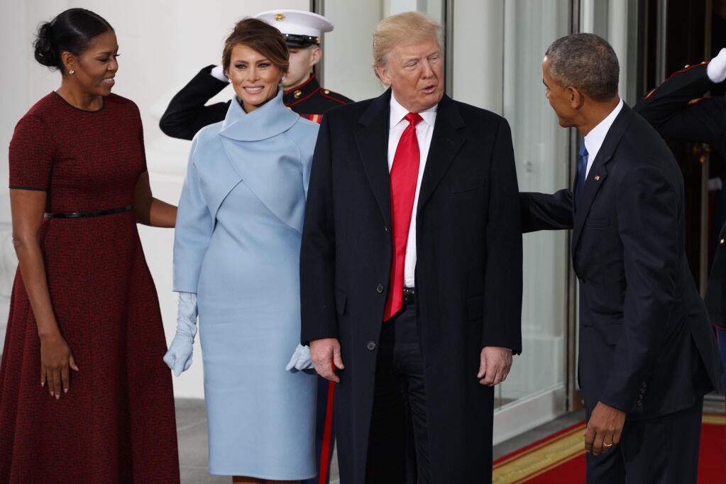 President Barack Obama and first lady Michelle Obama greet President-elect Donald Trump and Melania Trump at the White House, Friday, Jan. 20, 2017, in Washington. (AP Photo/Evan Vucci)