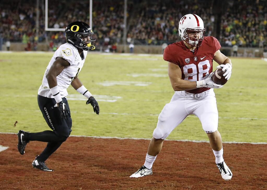 Stanford tight end Greg Taboada (88) catches a touchdown pass over Oregon defensive back Arrion Springs (1) Saturday, Nov. 14, 2015, in Stanford. (AP Photo/Tony Avelar)