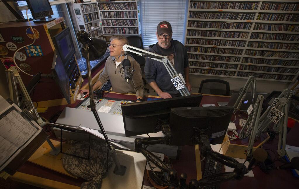 Announcer Mark Prell, left, and Music Director Brian Griffith work the sound board for the morning radio program at KRCB Northern California Public Media in Rohnert Park. (photo by John Burgess/The Press Democrat)