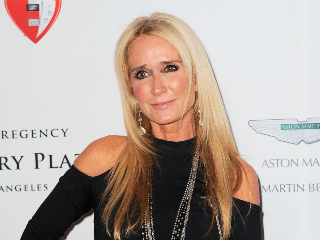 FILE - In this May 3, 2013 file photo, TV personality Kim Richards arrives at the 20th annual Race to Erase MS event 'Love to Erase MS' in Los Angeles. Richards, one of the Bravo series, 'Real Housewives of Beverly Hills,' was arrested Thursday, April 16, 2015, on suspicion of being drunk in public. Police say she was belligerent, had slurred speech, cursed the officers and kicked one in the leg. She was booked for public intoxication, trespassing, resisting and battery on an officer. (Photo by Jordan Strauss/Invision/AP, File)