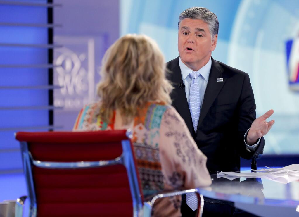 Fox News talk show host Sean Hannity interviews Roseanne Barr during a taping of his show, Thursday, July 26, 2018, in New York. Barr will appear on the Fox News show 'Hannity' on Thursday at 9 p.m. EDT for the first time since she was fired from ABC and her namesake show was canceled. ABC canceled its successful reboot of 'Roseanne' in May following the star's racist tweet likening former Obama adviser Valerie Jarrett to a cross between the Muslim Brotherhood and a 'Planet of the Apes' actor. (AP Photo/Julie Jacobson)