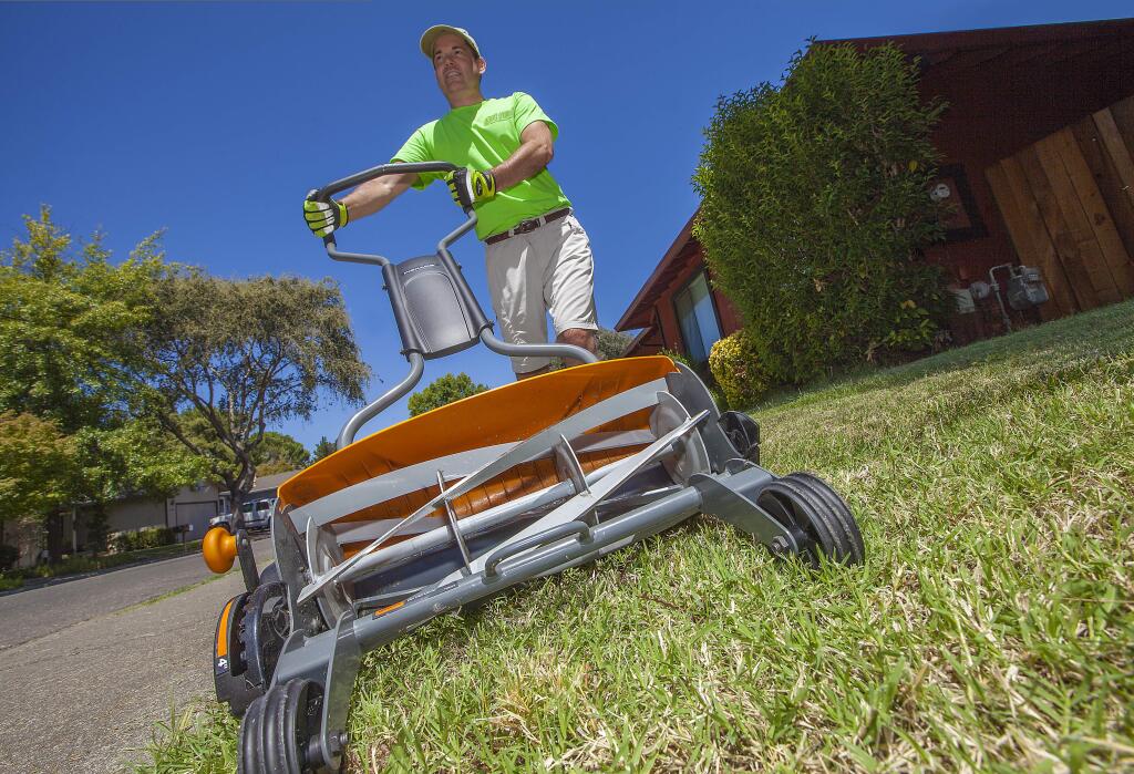 Pushmower Man!: Get Reel lawn care's Sterling Stevens is hoping to mow down the competition with his eco-friendly maintenance in a town undergoing a serious landscaping identity crisis. (Photo by Robbi Pengelly/Index-Tribune)