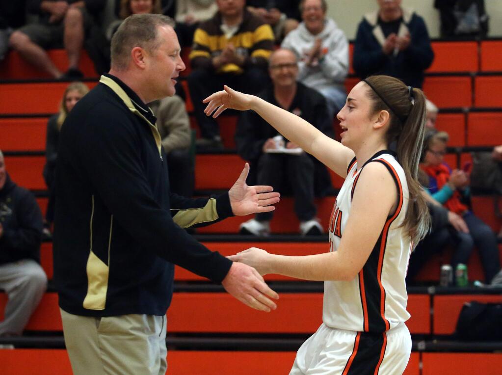 Every time the two teams meet, Windsor's assistant coach Erik Oden, left, receives a hug from his daughter Santa Rosa's Kylie Oden, right, before the start of the game held at Santa Rosa High School, Thursday, January 8, 2015. (Crista Jeremiason / The Press Democrat)