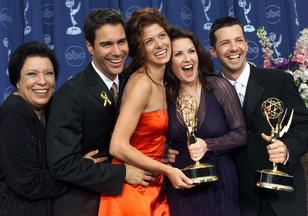FILE - In this Sept. 10, 2000, file photo, Shelley Morrison, from left, Eric McCormack, Debra Messing, Megan Mullally and Sean Hayes celebrate their awards for their work in 'Will & Grace' at the 52nd annual Primetime Emmy Awards in Los Angeles. Morrison, an actress with a 50-year career who was best known for playing a memorable maid on “Will and Grace,” has died. Publicist Lori DeWaal says Morrison died Sunday, Dec. 1, 2019, at Cedars-Sinai Medical Center in Los Angeles from heart failure. She was 83. (AP Photo/Kevork Djansezian, File)