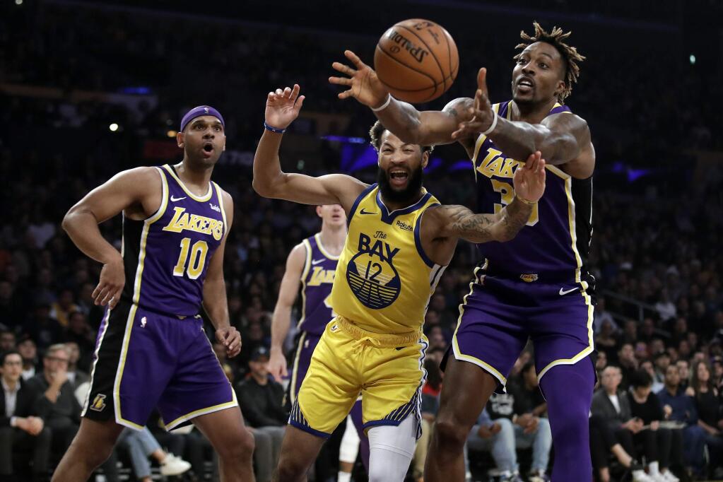 The Los Angeles Lakers' Dwight Howard, right, grabs a rebound over the Golden State Warriors' Ky Bowman during the first half Wednesday, Nov. 13, 2019, in Los Angeles. (AP Photo/Marcio Jose Sanchez)