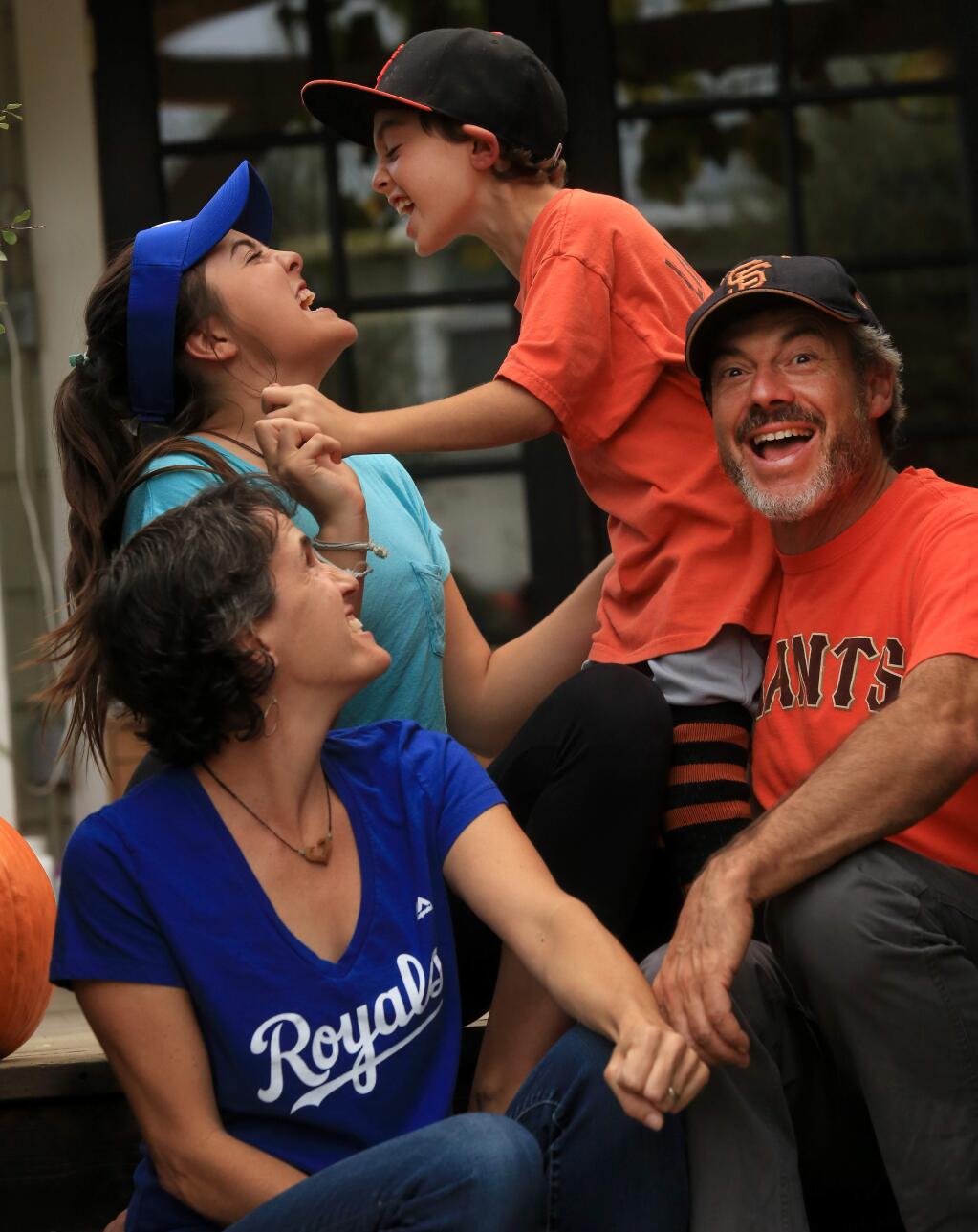 Royals vs Giants…Tina Howa and her husband Adam Goldberg like two different teams, she the Royals and he the Giants. They've passed along the genes to their children Bella Goldberg, left and Eli Goldberg, right, Thursday Oct. 23, 2014. (Kent Porter / Press Democrat) 2014