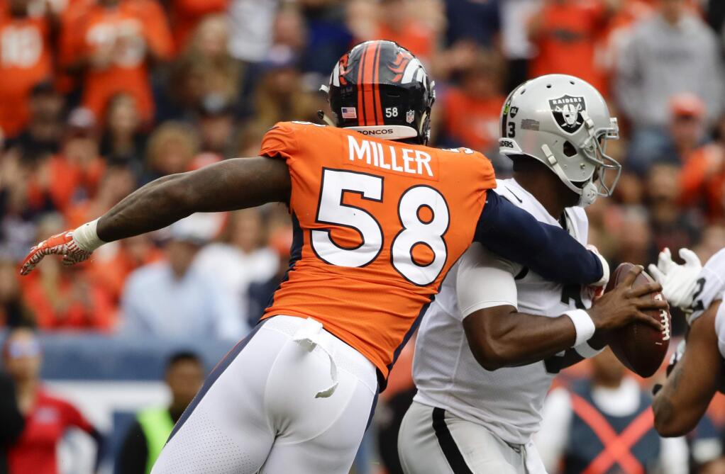 Denver Broncos outside linebacker Von Miller, left, sacks Oakland Raiders quarterback E.J. Manuel during the second half Sunday, Oct. 1, 2017, in Denver. (AP Photo/Jack Dempsey)