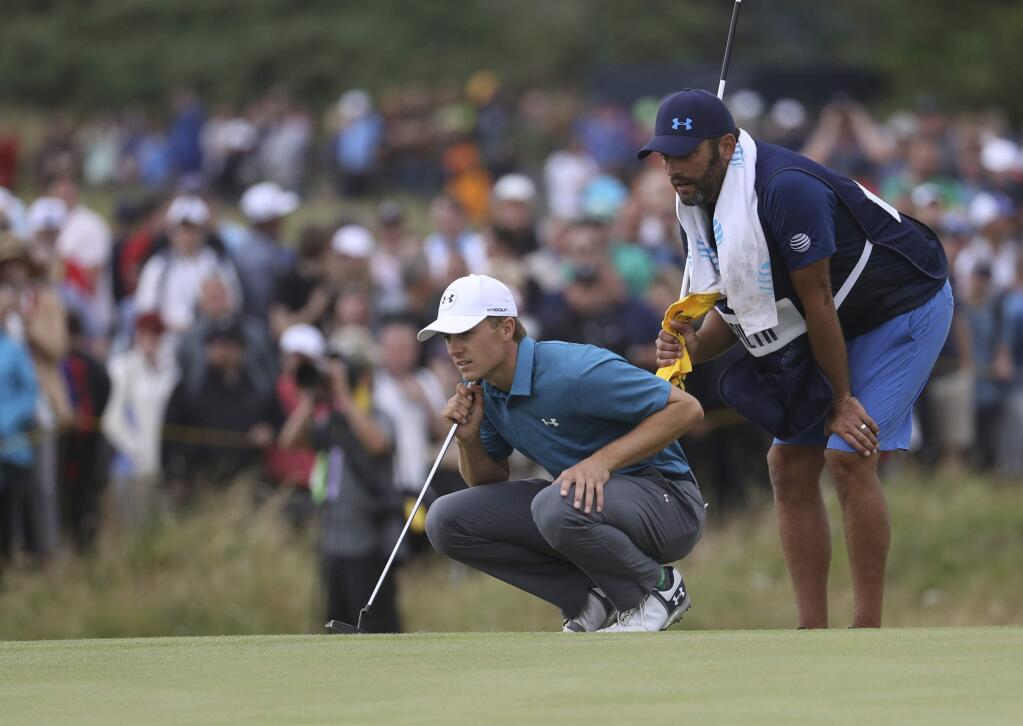 Jordan Spieth of the United States and his caddie Michael Greiler line up a putt on the 9th green during the final round of the British Open Golf Championship, at Royal Birkdale, Southport, England, Sunday July 23, 2017. (AP Photo/Peter Morrison)