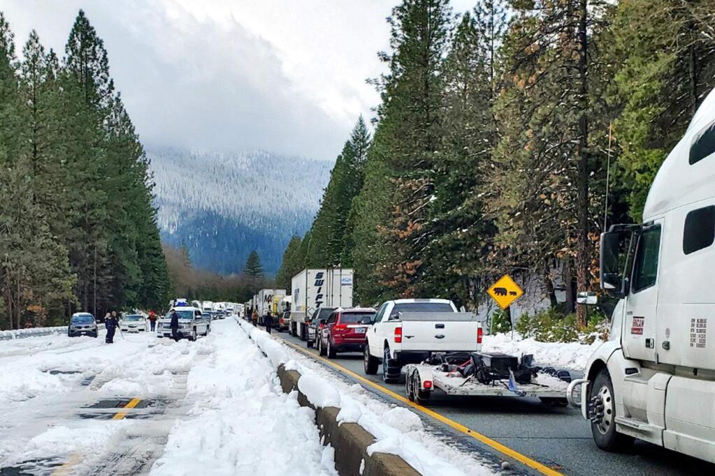 This photo provided by Caltrans shows cars and trucks in stopped traffic on Interstate 5 near Dunsmuir, Calif., Wednesday, Nov. 27, 2019. Thanksgiving travel has been snarled in some places by two powerful storms. A winter storm blamed for one death and hundreds of canceled flights in the West moved into the Midwest on Wednesday and dropped close to a foot of snow in parts of Minnesota and Wisconsin. (Caltrans via AP)