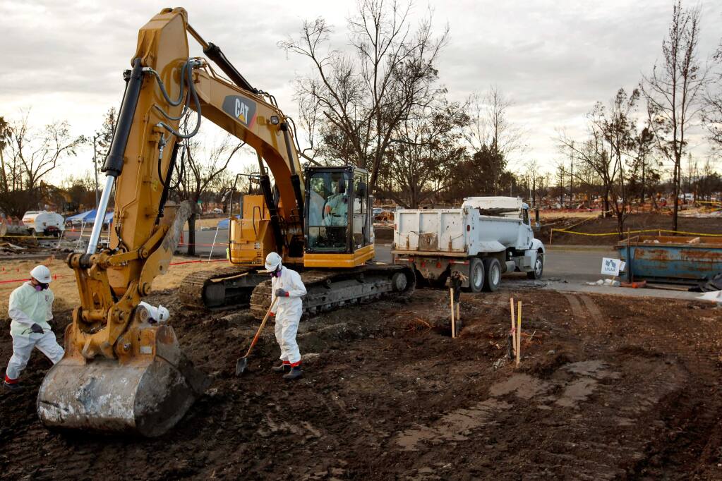 An excavator crew from Ghilotti Construction Company finishes clearing the burned debris and concrete from a property in the Coffey Park neighborhood in Santa Rosa, California on Tuesday, November 28, 2017. (Alvin Jornada / The Press Democrat)