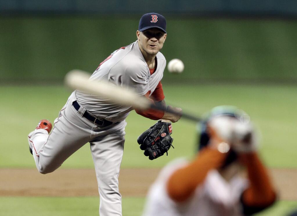 Boston Red Sox's Jake Peavy, left, delivers a pitch to Houston Astros' Jose Altuve in the first inning of a baseball game Saturday, July 12, 2014, in Houston. (AP Photo/Pat Sullivan)