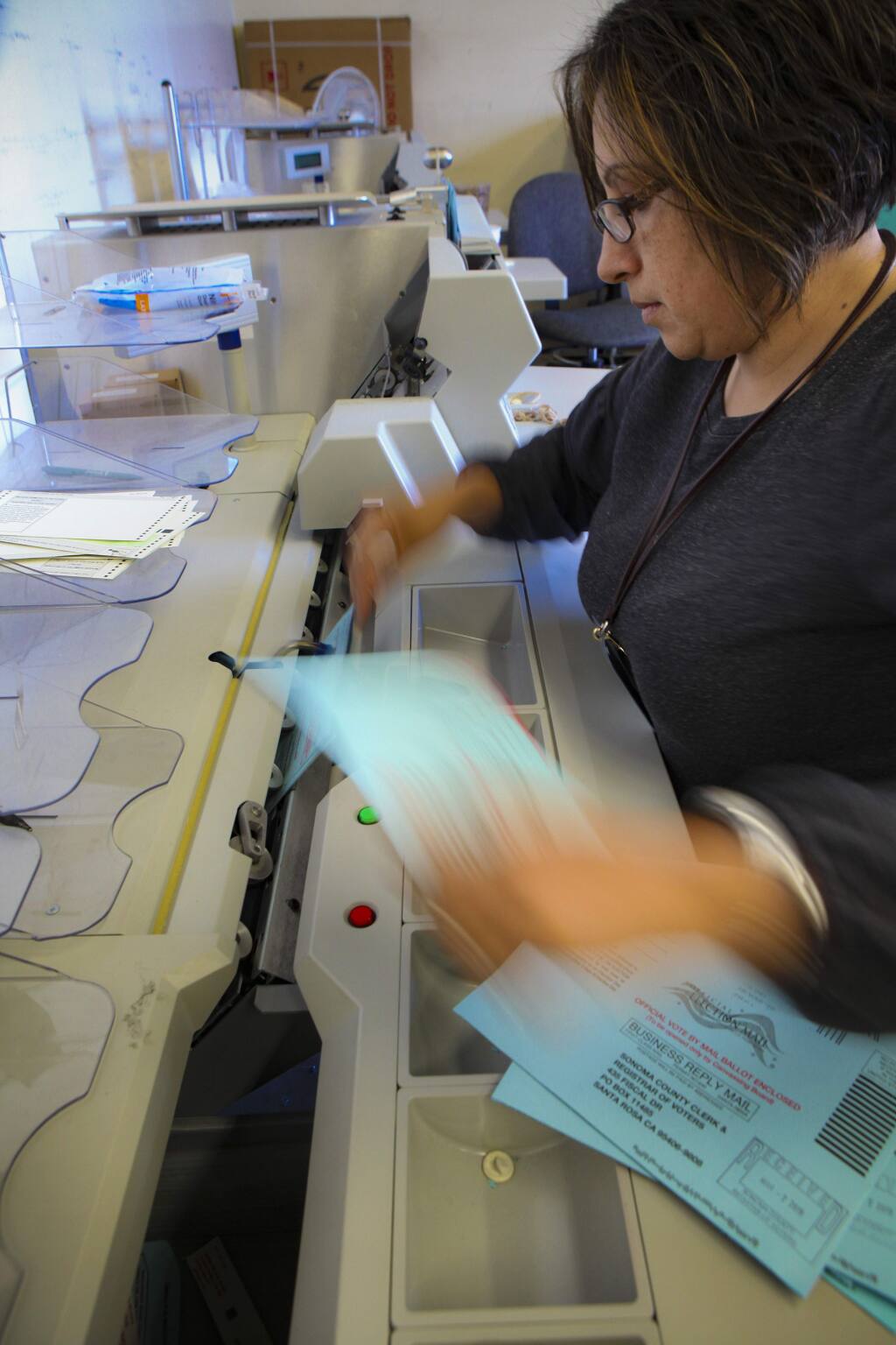 Ibon Suazo, Senior Election Specialist works with the extractor for the ballots cast in the recent special election. The Registrar of Voters debuted a new election vote tallying system.(CRISSY PASCUAL/ARGUS-COURIER STAFF)