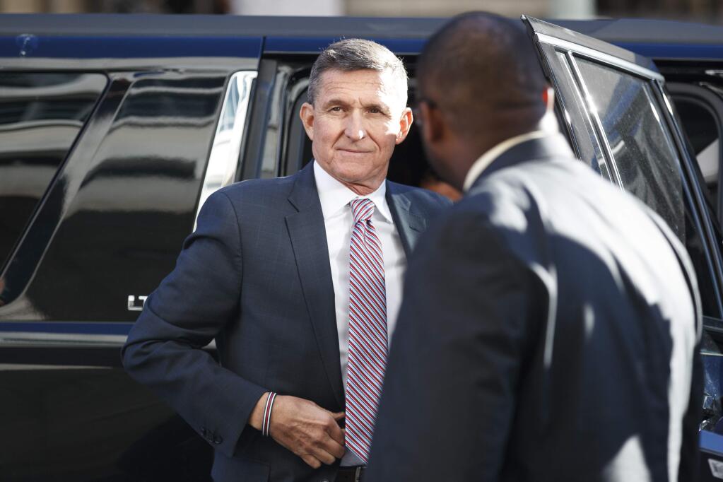 FILE - In this Dec. 18, 2018, file photo, President Donald Trump's former national security adviser Michael Flynn arrives at federal court in Washington. Flynn told the special counsel's office that people connected to the Trump administration and Congress contacted him about his cooperation with the Russia investigation. That's according to a court filing from prosecutors Thursday, May 16, 2019, that describes the extent of Flynn's cooperation with the probe. (AP Photo/Carolyn Kaster, File)