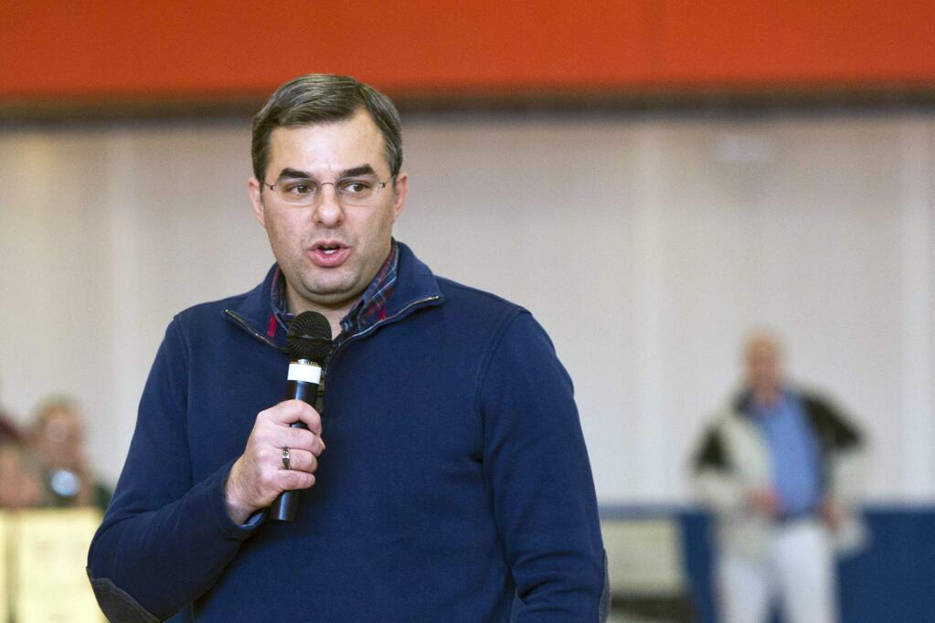 FILE - In this Thursday, Feb. 23, 2017 file photo, U.S Rep. Justin Amash, R-Cascade Township, speaks to the audience during a town hall meeting at the Full Blast Recreation Center in Battle Creek, Mich. Amash, a Republican congressman from Michigan says he's concluded that President Donald Trump has “engaged in impeachable conduct.” Congressman Justin Amash tweeted Saturday, May 18, 2019 that he has read the entire redacted version of special counsel Robert Mueller's Russia report. (Carly Geraci//Kalamazoo Gazette via AP, File)