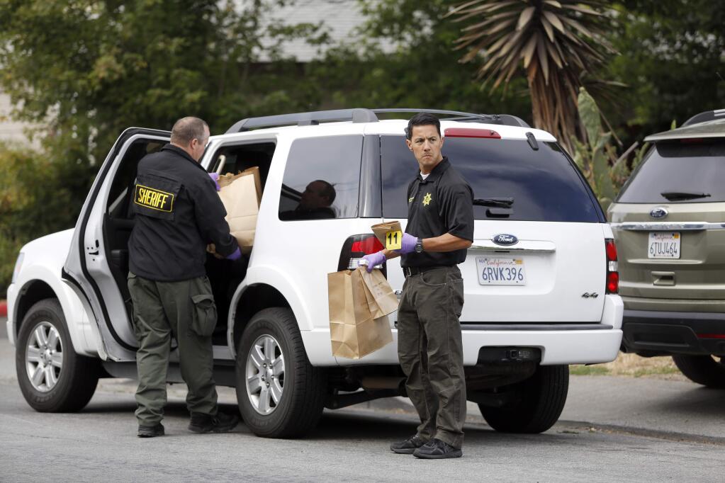 Sonoma County sheriff's deputies and detectives collect evidence from a gang-related shooting near a Corby Avenue apartment complex in Santa Rosa, July 6, 2015. (BETH SCHLANKER/ The Press Democrat)