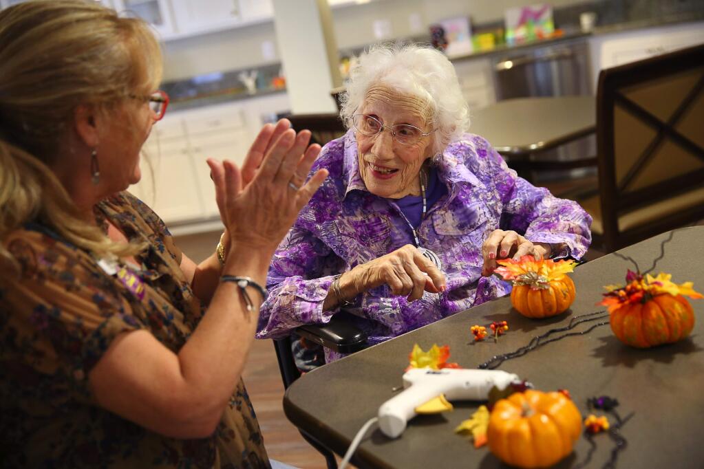 Ann Beach Burow, right, works on decorating a pumpkin with Cindy Titus, activities assistant at Vintage Brush Creek Vintage Senior Living, in Santa Rosa, on Friday, October 16, 2015. Burow will be turning 110-years-old on Friday, October 23, 2015.(Christopher Chung/ The Press Democrat)