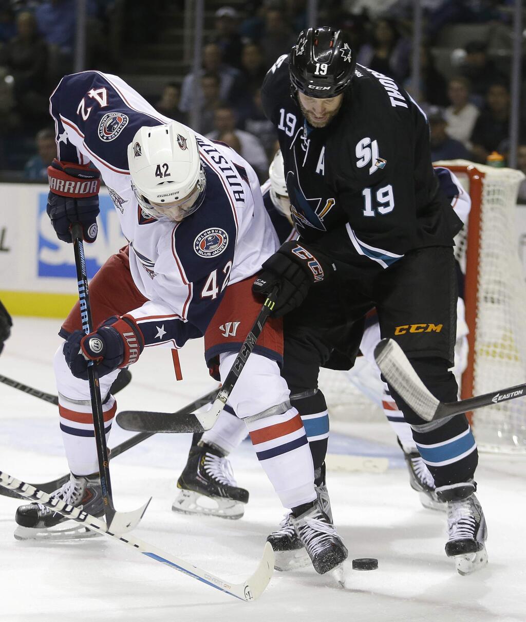 Columbus Blue Jackets' Artem Anisimov, left, and San Jose Sharks' Joe Thornton vie for the puck during the first period of an NHL hockey game Thursday, Oct. 23, 2014, in San Jose. (AP Photo/Ben Margot)