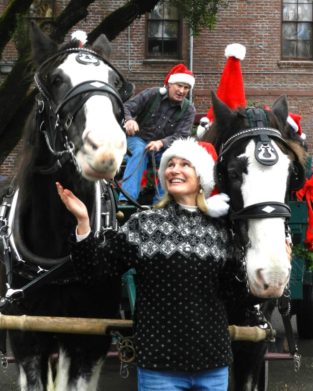 Yvonne Soto-Pomeroy/Index-TribuneCaroling in Glen EllenSaturday, numerous children and adults took part in caroling through Glen Ellen. Here, Karen Buchanan, Neil Shepard's assistant, pets the horses during one of the stopovers to pick up more carolers. In addition to getting to ride in Shepard's wagon, the boys and girls and their parents sang carols, accompanied as usual by Bob Gossett on his guitar. And s a special treat, Santa rode along and passed out candy canes along with plenty of Christmas good will.