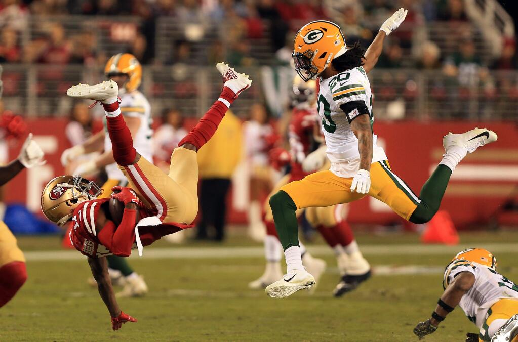 Emmanuel Sanders of the 49ers vaults to a first down as Kevin King of the Packers pursues, during San Francisco's 37-8 win over Green Bay, Sunday, Nov. 24, 2019 in Santa Clara. (Kent Porter / The Press Democrat) 2019