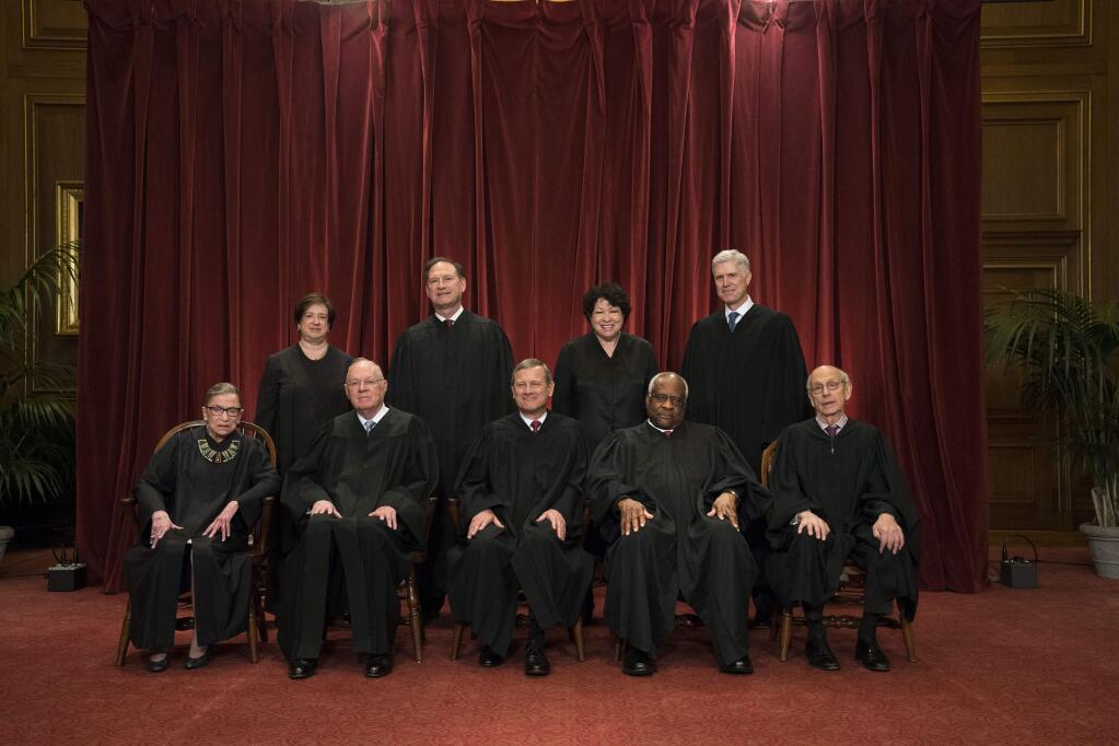 The justices of the U.S. Supreme Court sit for a group portrait last month in Washington. (DOUG MILLS / New York Times)