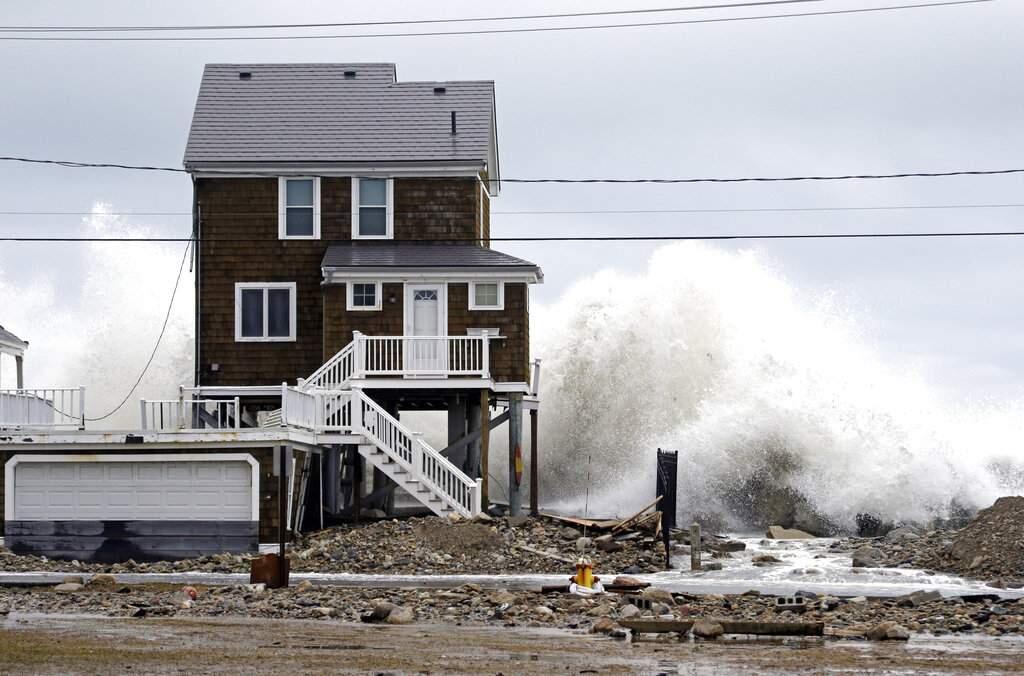 A house continues to get pummeled by high surf, Tuesday, March 6, 2018, as waves continue to breach the seawall in Marshfield, Mass. Utilities are racing to restore power to tens of thousands of customers in the Northeast still without electricity after last week's storm as another nor'easter threatens the hard-hit area with heavy, wet snow, high winds, and more outages. (AP Photo/Elise Amendola)
