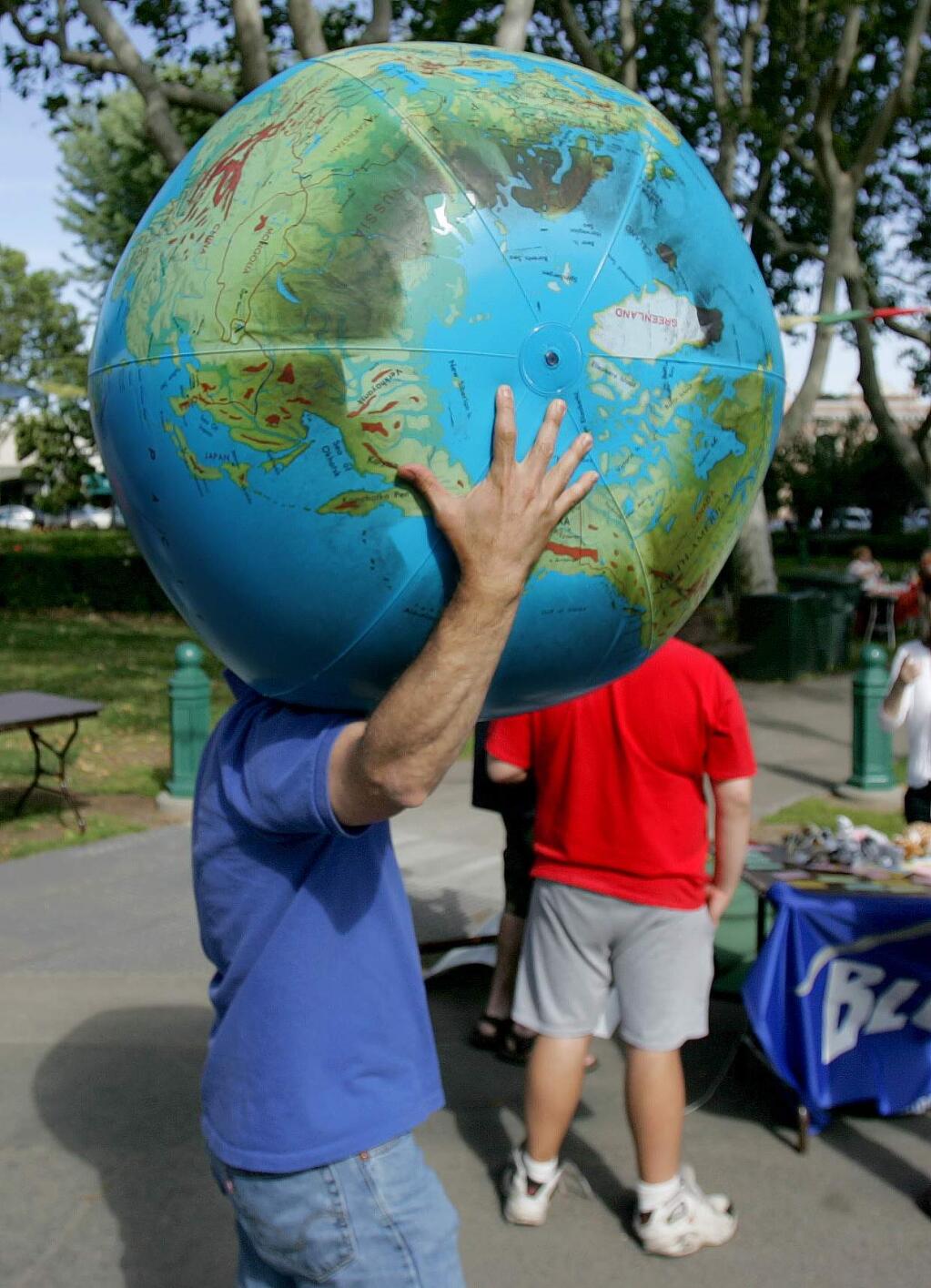 A visitor to Sonoma carries the weight of the world on his shoulders during an previous year's Earth Day event at Sonoma Plaza. (PC File photo)